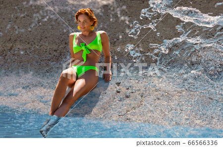 Woman on holiday with bikini 66566336