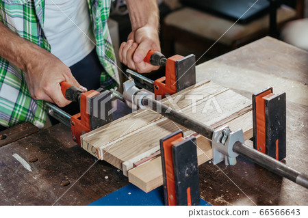 Bonding wood in the workshop. The use of glue for different types of wood. Making worktops for the kitchen. Work as a craftsman. Creating a cutting board design 66566643
