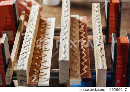 Bonding wood in the workshop. The use of glue for different types of wood. Making worktops for the kitchen. Work as a craftsman. Creating a cutting board design Bonding wood in the workshop. The use of glue for different types of wood. Making worktops for the kitchen. Work as a craftsman. Creating a cutting board design 66566647