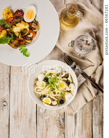 Salad with squid rings, mozzarella cheese, olives Salad with squid rings, mozzarella cheese, olives 66567281