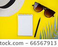 Notebook, pen, sunglasses, palm leaf, hat on yellow background. Summer, travel concept. Top view, flat lay, copy space, mock up 66567913
