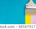 Paint brush, yellow pink paper stroke on turquoise background. Repairs concept. Top view, flat lay, copy space 66567917