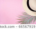 Hat and palm leaf decor frame on pink background. Summer, travel concept. Top view, flat lay, copy space 66567919