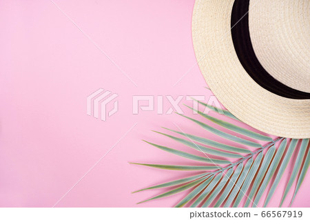Hat and palm leaf decor frame on pink background. Summer, travel concept. Top view, flat lay, copy space Hat and palm leaf decor frame on pink background. Summer, travel concept. Top view, flat lay, copy space 66567919