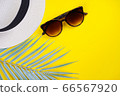 Hat, palm leaf decor, sunglasses on yellow background. Summer, travel concept. Top view, flat lay, copy space 66567920