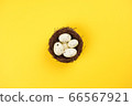 Nest with eggs on bright yellow background. Easter concept. Flat lay, top view, copy space 66567921