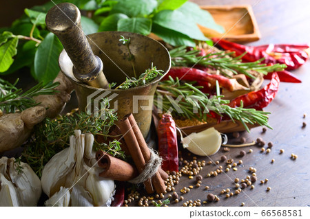 Different herbs and spices on a wooden table . 66568581
