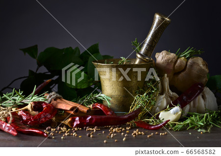 Different herbs and spices on a wooden table . 66568582