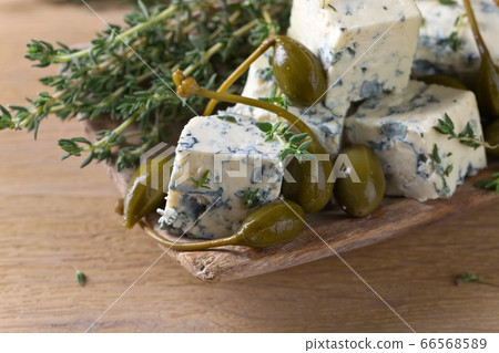 Blue cheese , capers and branches of thyme. Blue cheese , capers and branches of thyme. 66568589