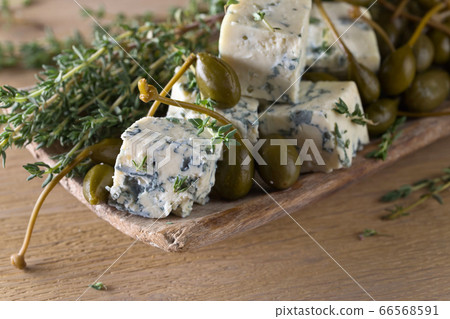 Blue cheese , capers and branches of thyme. Blue cheese , capers and branches of thyme. 66568591