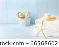 Close up of starfish and white towels with Facial cleansing brush 66568602