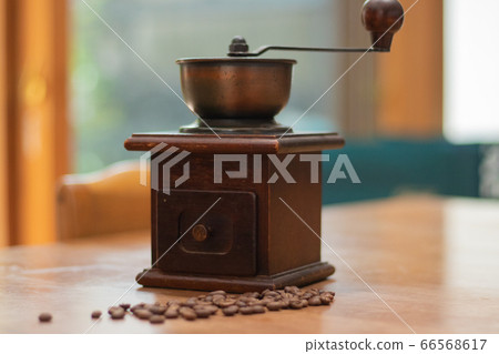 Grind coffee beans with a coffee grinder 66568617