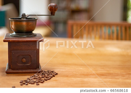 Grind coffee beans with a coffee grinder 66568618