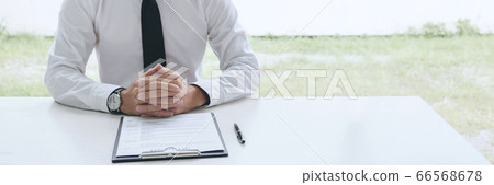 Interviewer or Board reading a resume during a job Interviewer or Board reading a resume during a job 66568678