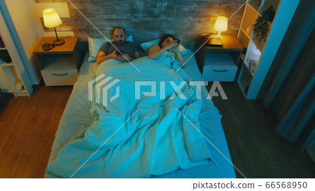 Couple under the sheet late at night Couple under the sheet late at night 66568950