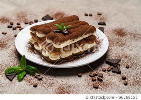 Classic tiramisu dessert on ceramic plate on concrete background Classic tiramisu dessert on ceramic plate on concrete background 66569153