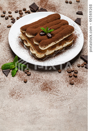 Classic tiramisu dessert on ceramic plate on concrete background 66569168
