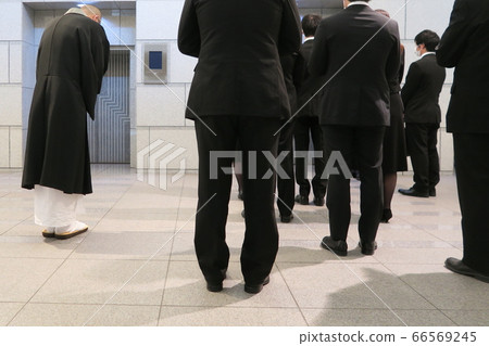 Priests and survivors working together in front of the cremation furnace 66569245
