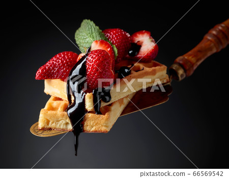 Belgian waffles with strawberries, mint and 66569542