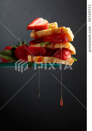 Belgian waffles with strawberries and honey 66569551