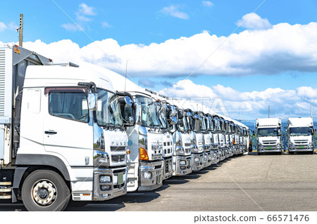 Trucks lined up by a shipping company Trucks lined up by a shipping company 66571476