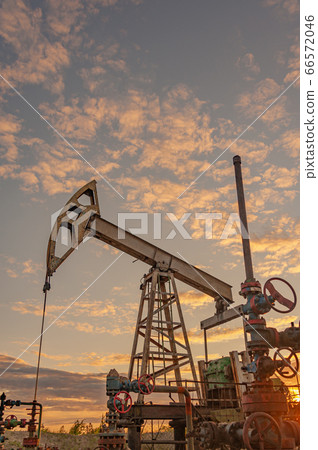 Petroleum concept. Oil pump rig. Oil and gas production. Oilfield site. Pump Jack are running. Drilling derricks for fossil fuels output and crude oil production. Global crisis. War on oil prices. Petroleum concept. Oil pump rig. Oil and gas production. Oilfield site. Pump Jack are running. Drilling derricks for fossil fuels output and crude oil production. Global crisis. War on oil prices. 66572046