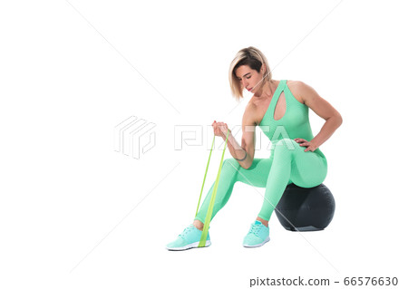 Woman exercising fitness resistance bands in studio silhouette isolated on white background Woman exercising fitness resistance bands in studio silhouette isolated on white background 66576630