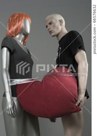 male and female mannequin. holding a heart in male and female mannequin. holding a heart in 66576632