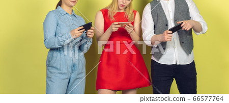 Group of friends using mobile smartphones. Teenagers addiction to new technology trends. Close up. Group of friends using mobile smartphones. Teenagers addiction to new technology trends. Close up. 66577764