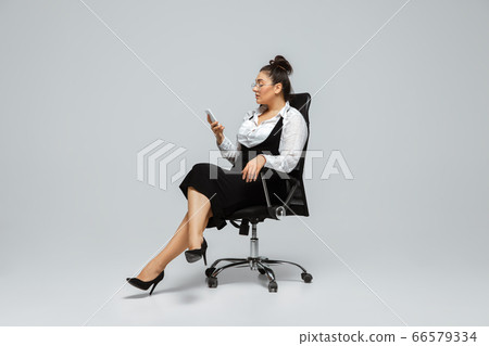 Young caucasian woman in office attire. Bodypositive female character. plus size businesswoman Young caucasian woman in office attire. Bodypositive female character. plus size businesswoman 66579334