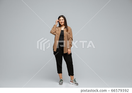 Young caucasian woman in casual wear. Bodypositive female character, plus size businesswoman 66579392