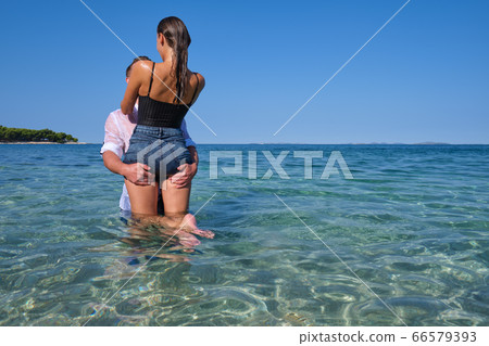 Happy couple in love on beach summer vacations. 66579393