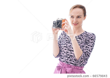 Young woman using a camera Young woman using a camera 66579843