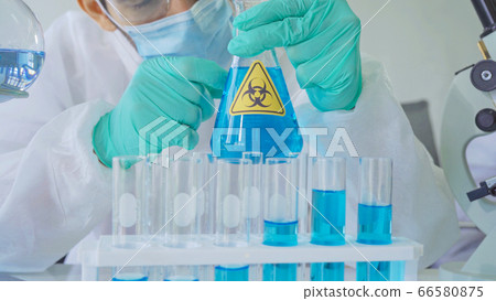 Asian Scientist working on blue test tube to Asian Scientist working on blue test tube to 66580875