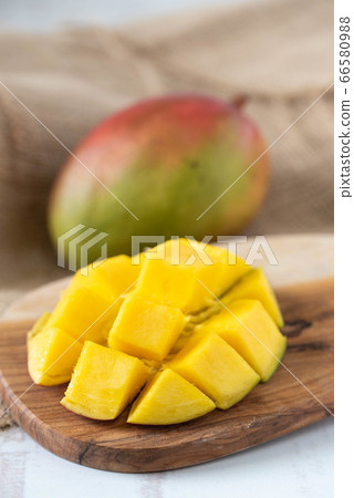 whole and cutted mango on wooden background whole and cutted mango on wooden background 66580988