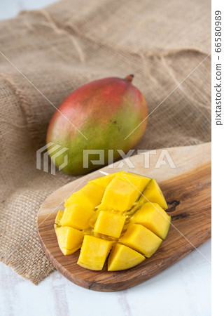 whole and cutted mango on wooden background whole and cutted mango on wooden background 66580989