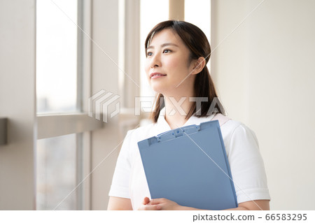Medical worker woman looking at the future by the window Medical worker woman looking at the future by the window 66583295