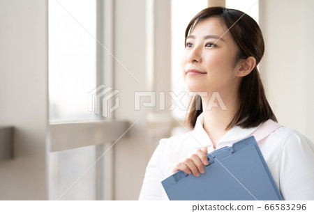 Medical worker woman looking at the future by the window Medical worker woman looking at the future by the window 66583296
