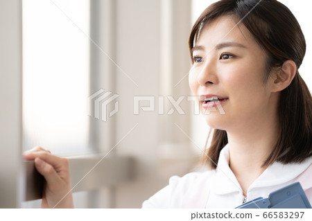 Medical worker woman looking at the future by the window Medical worker woman looking at the future by the window 66583297
