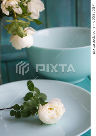 Romantic table setting with bouquet of roses, dishware, on holiday teal table. Romantic and wedding anniversary. Romantic table setting with bouquet of roses, dishware, on holiday teal table. Romantic and wedding anniversary. 66583587