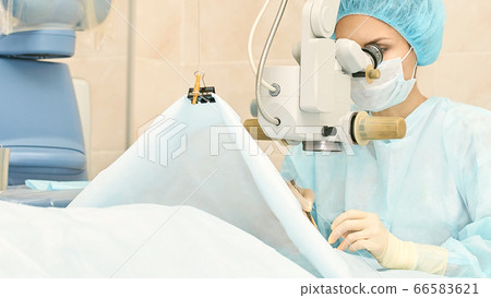 Ophthalmology laser microscope operation. Doctor in clinic. Patient eye treatment. Myopia and cataract removal Ophthalmology laser microscope operation. Doctor in clinic. Patient eye treatment. Myopia and cataract removal 66583621