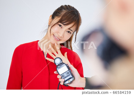 紅色外套和攝影師的年輕女模特 66584159