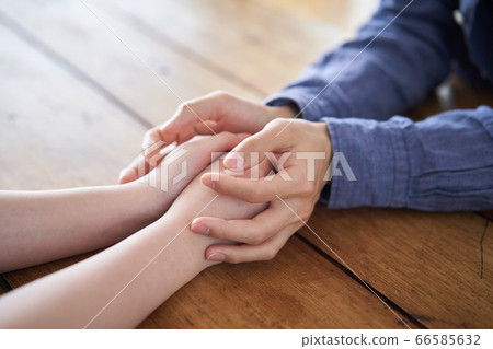 A young couple holding hands A young couple holding hands 66585632