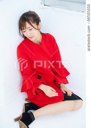 Young female model in a red coat 66585858