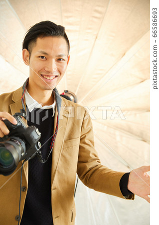 Young photographer with camera Young photographer with camera 66586693