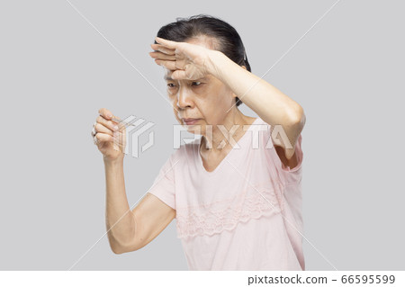 old asian woman feel have fever and sick	 66595599