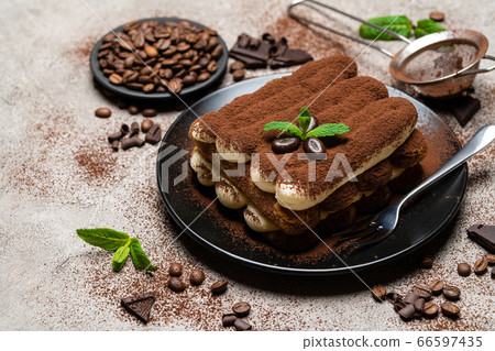 Classic tiramisu dessert on ceramic plate on concrete background 66597435