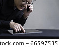 Business owner busy using smartphone and digital tablet making ecommerce 66597535