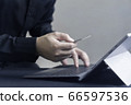 Man paying online by credit card with digital tablet or computer laptop 66597536