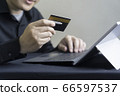 Man paying online by credit card with digital tablet or computer laptop 66597537